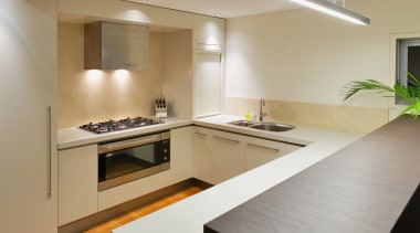 The kitchen is located on the lower floor, countertop, floor, interior design, kitchen, property, real estate, room, gray