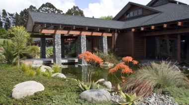 View of the entrance way which features schist backyard, cottage, estate, garden, home, house, landscape, landscaping, outdoor structure, plant, pond, property, real estate, yard