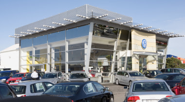 View of Tristram European's new VW showroom which building, car, car dealership, commercial building, corporate headquarters, family car, luxury vehicle, mixed use, motor vehicle, vehicle, teal