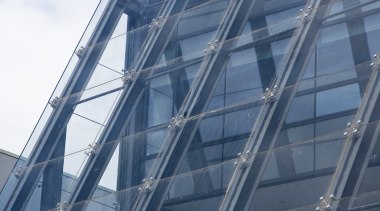 Heritage Glass designed and installed the sloping glass architecture, building, commercial building, corporate headquarters, daylighting, daytime, facade, headquarters, line, metropolis, metropolitan area, sky, skyscraper, structure, tower block, urban area, blue