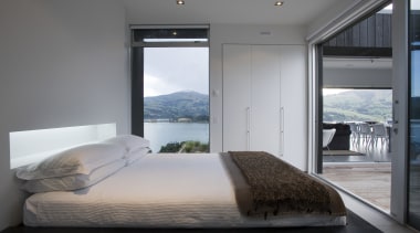 view of bedroom which features glass sliding doors, bedroom, interior design, room, suite, window, gray