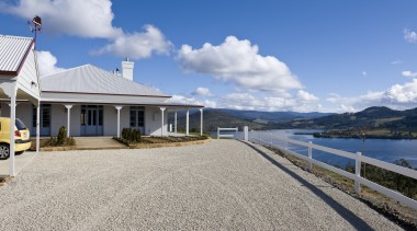 Exterior view of Victorian-syle house featuring steel roofing, cloud, coast, cottage, estate, home, house, mountain, property, real estate, sky, villa, water, gray