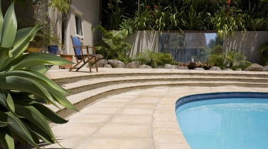 View of a pool with paving that features arecales, backyard, landscaping, leisure, outdoor structure, plant, real estate, swimming pool, walkway, water, yard, brown, orange