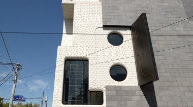 Exterior view of the MRC which features wrought architecture, building, facade, house, residential area, sky, wall, blue, gray