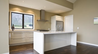 view of a show home kitchen where the cabinetry, ceiling, countertop, floor, flooring, hardwood, home, interior design, kitchen, laminate flooring, property, real estate, room, wood flooring, gray, brown