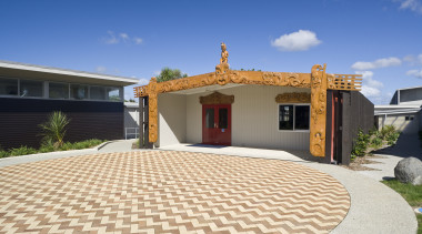 Exterior view of Tupuranga school which was designed elevation, estate, facade, home, house, property, real estate, residential area, roof, sky, villa