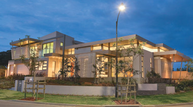 Exterior view of a contemporary home designed by apartment, architecture, building, condominium, cottage, elevation, estate, facade, home, house, mixed use, neighbourhood, property, real estate, residential area, sky, suburb, teal