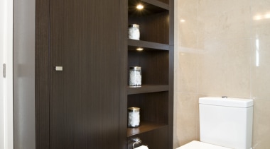 View of a bathroom desiged by a Yellow bathroom, bathroom accessory, bathroom cabinet, cabinetry, interior design, plumbing fixture, room, gray