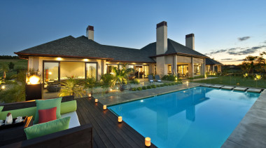 View of contemporary home with light-toned and beige estate, home, house, leisure, property, real estate, resort, sky, swimming pool, villa, teal