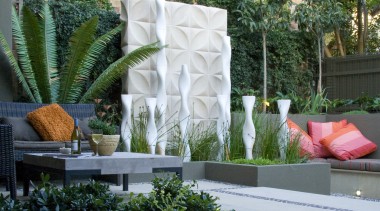 View of outdoor living area and courtyard featuring arecales, backyard, courtyard, flora, floristry, flower, flower arranging, flowerpot, garden, landscaping, outdoor structure, plant, gray