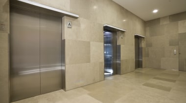 View of one of the lifts inside the architecture, floor, flooring, interior design, lobby, property, real estate, tile, wall, brown, orange