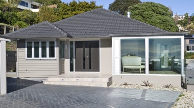 Exterior view of a renovated house which was cottage, elevation, estate, facade, home, house, property, real estate, residential area, siding, window, gray