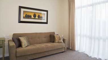 View of a living area inside an apartment floor, furniture, home, interior design, living room, property, real estate, room, suite, window, window covering, window treatment, gray