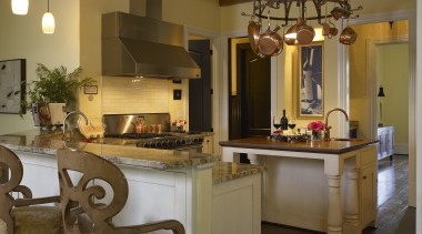 View of an open-plan kitchen featuring a central ceiling, countertop, interior design, kitchen, lighting, room, brown