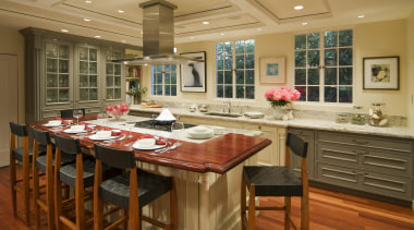 View of a French-styled kitchen featuring island, granite cabinetry, countertop, cuisine classique, interior design, kitchen, room, brown, orange