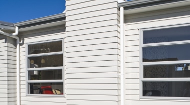 Exterior view of Harmony Homes show home which architecture, building, elevation, facade, home, house, property, real estate, residential area, siding, sky, window, white, blue