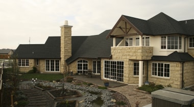 Exterior view of a home which features block cottage, elevation, estate, home, house, outdoor structure, property, real estate, residential area, roof, siding, window, black, white