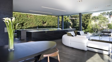 View of open-plan kitchen and living area featuring architecture, home, house, interior design, living room, property, real estate, gray, black