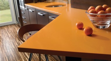 view of a kitchen which features an orange chair, countertop, floor, flooring, furniture, hardwood, interior design, kitchen, laminate flooring, room, table, wood, wood flooring, wood stain, brown, orange