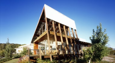 Exterior view of a canal-side beach house which architecture, cottage, estate, farmhouse, home, house, property, real estate, sky, blue