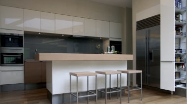 View of open-plan kitchen area featuring island woodgrain cabinetry, ceiling, countertop, floor, flooring, hardwood, interior design, kitchen, laminate flooring, room, wood, wood flooring, gray