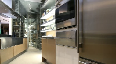View of wet kitchen featuring large rangehood and architecture, floor, interior design, kitchen, gray