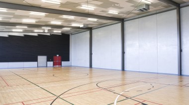 View of the Tupuranga School gymnasium which features basketball court, ceiling, floor, flooring, hall, hardwood, indoor games and sports, leisure centre, net, sport venue, sports, structure, wood, wood flooring, orange