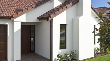 Exterior view of home featuring brick cladding, doors architecture, building, cottage, estate, facade, hacienda, home, house, property, real estate, residential area, roof, sky, villa, gray