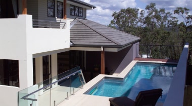 Exterior pool view of the Augusta home. Built estate, home, house, property, real estate, roof, swimming pool, villa, window, white, black