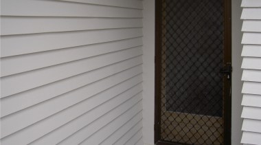 Qmulus BIB dry-fibre insulation being installed by an door, facade, floor, home, shade, siding, wall, window, window blind, window covering, window screen, window treatment, wood, wood stain, gray, black