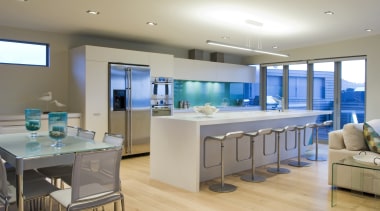 This sleek kitchen in a beach house features countertop, interior design, kitchen, real estate, room, gray