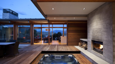 View of spa area with outdoor fireplace and architecture, estate, home, house, interior design, lighting, living room, real estate, swimming pool, window, wood, brown
