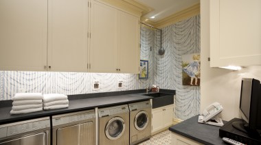 Interior view of this laundry area which features countertop, home, interior design, kitchen, laundry, laundry room, property, real estate, room, orange