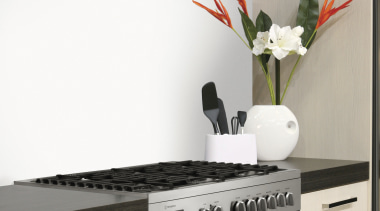 This chic kitchen features a bottom-mount refrigerator, oven, countertop, home appliance, interior design, kitchen, kitchen appliance, kitchen stove, major appliance, microwave oven, product, product design, small appliance, white