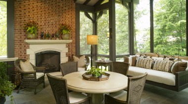 Traditional style living area featuring fireplace &amp; furniture backyard, home, interior design, living room, outdoor structure, patio, porch, real estate, table, window, brown
