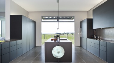 View of a contemporary kitchen which features island, architecture, countertop, interior design, kitchen, product design, real estate, room, gray, white