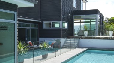 Poolside view of the contemporary home. - Poolside architecture, estate, facade, home, house, leisure, leisure centre, property, real estate, swimming pool, water, teal, white