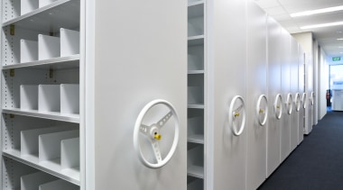 View of adjustable storage shelves with lockable handwheels. product, product design, shelving, white, gray