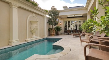 View of this pool and patio features outdoor apartment, estate, hacienda, home, house, leisure, property, real estate, resort, swimming pool, villa, gray, brown