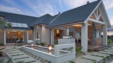 Exterior View of a masonry house built by cottage, elevation, estate, facade, home, house, property, real estate, residential area, roof, villa, gray