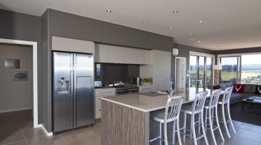 View of the kitchen area which features an countertop, floor, interior design, kitchen, property, real estate, gray