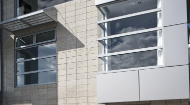 Exterior view of a contemporary home which features architecture, building, commercial building, condominium, corporate headquarters, elevation, facade, home, house, real estate, residential area, window, gray