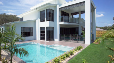 Exterior view of the rear of a home architecture, elevation, estate, facade, home, house, mansion, official residence, property, real estate, swimming pool, villa, window, teal