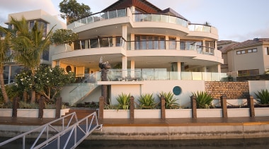 Exterior view of a home designed by TJV apartment, arecales, building, condominium, estate, facade, home, hotel, house, mansion, mixed use, palm tree, property, real estate, residential area, resort, swimming pool, villa, brown