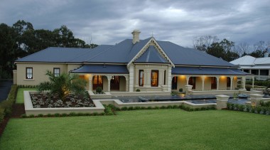 Exterior view of a traditional-styled home designed and cottage, elevation, estate, facade, farmhouse, grass, home, house, landscape, mansion, property, real estate, residential area, roof, villa, window, teal, green