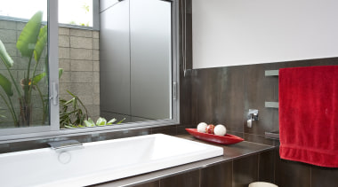 View of bathroom which features dark brown floor architecture, bathroom, countertop, interior design, real estate, room, window, gray, black