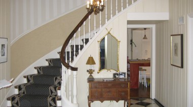 View of the stairway in this traditional house baluster, ceiling, floor, flooring, handrail, home, interior design, real estate, room, stairs, wall, gray