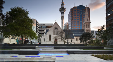 View of St Patrick's square featuring landscaping, paving, building, city, condominium, daytime, downtown, landmark, metropolitan area, neighbourhood, plaza, real estate, reflection, sky, tree, urban area, water, gray, black