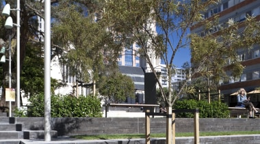 Exterior view of St Patrick's Square which features architecture, building, city, condominium, neighbourhood, plant, real estate, residential area, sky, tree, walkway, gray