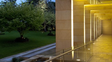 Exterior view of the sandstone hall - Exterior architecture, evening, home, house, light, light fixture, lighting, real estate, reflection, residential area, sky, street light, sunlight, tree, water, yellow, brown